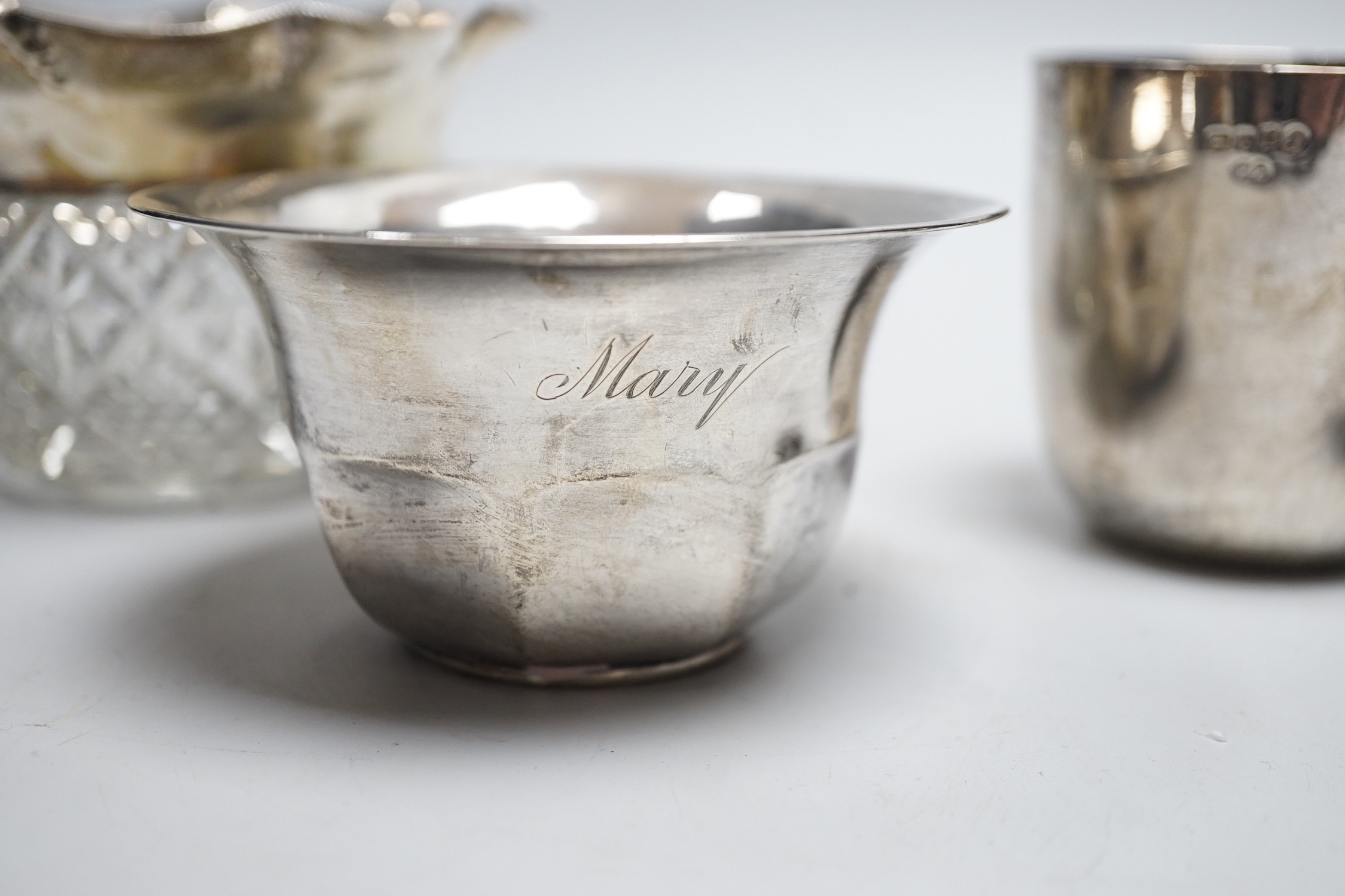 A Victorian silver tumbler cup, by Frederick Elkington, London, 1877, height 72mm, together with a silver mounted glass jar (lacking cover), a small silver bowl and an 800 white metal free-standing miniature model of a b